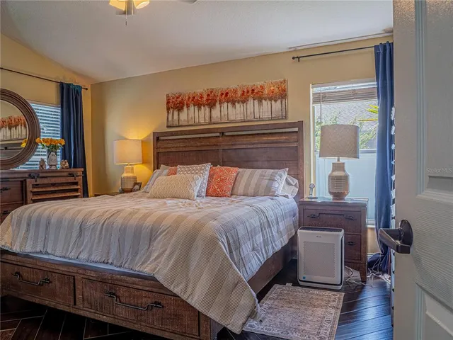 a bedroom with a bed and a mirror on dresser