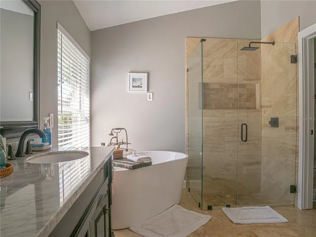a bathroom with a granite countertop sink a toilet and shower