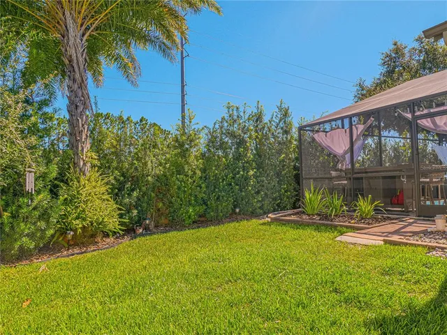 a view of a backyard with a garden and swimming pool