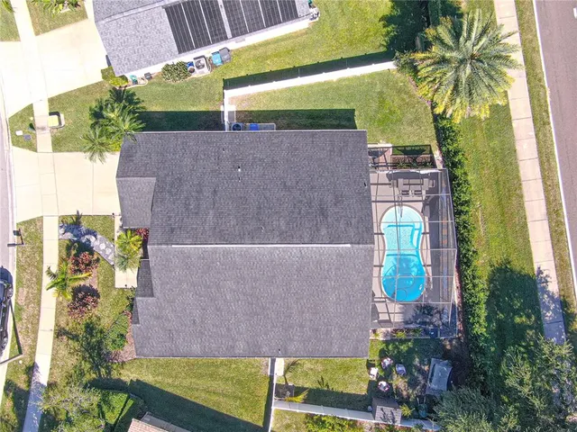 an aerial view of a house with a yard and potted plants
