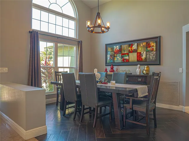 a view of a dining room with furniture wooden floor and chandelier