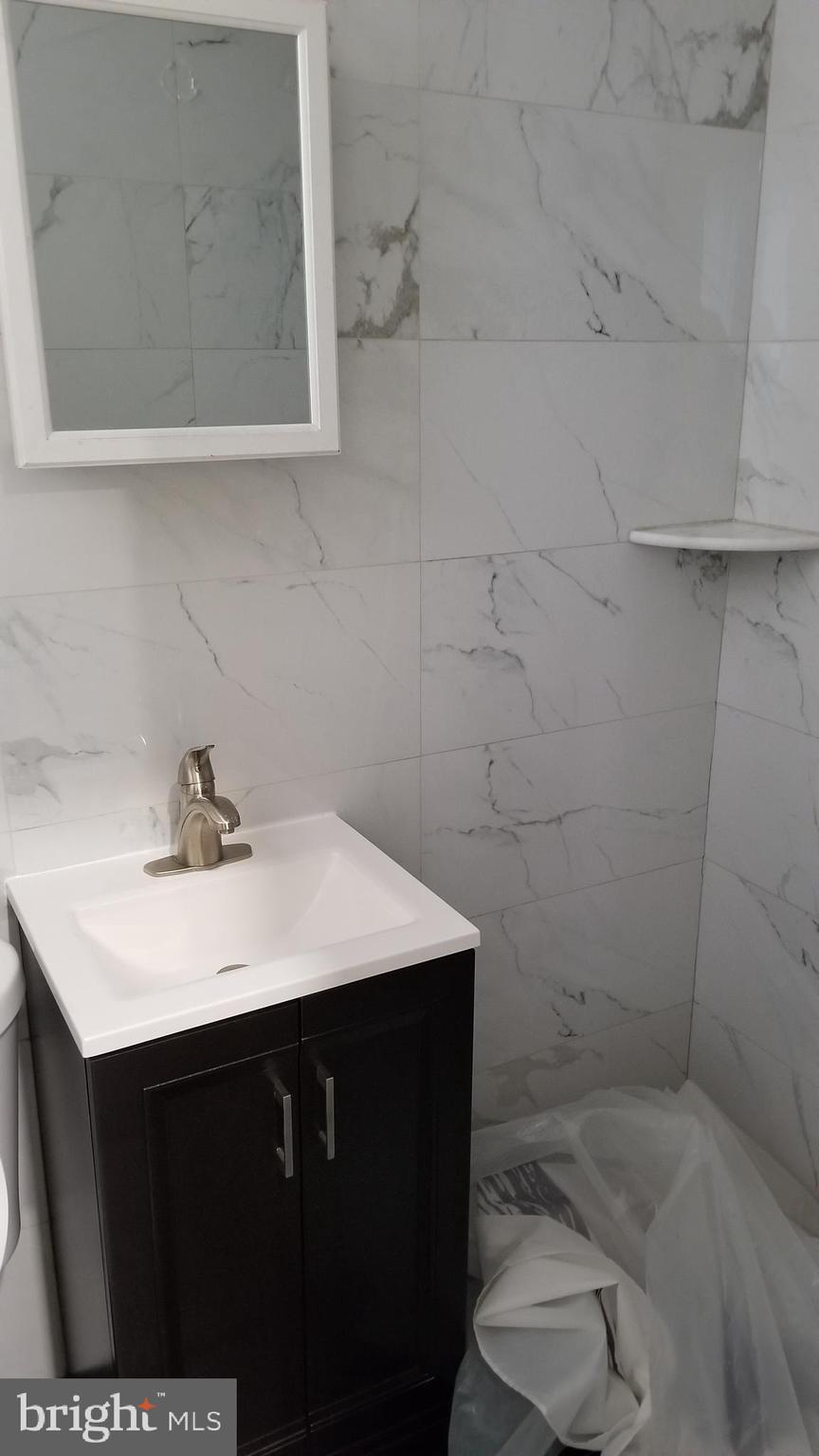 1120 Locust Street, Unit 301 Philadelphia, PA 19107 - Photo 5 of 9 a bathroom with a sink vanity and toilet