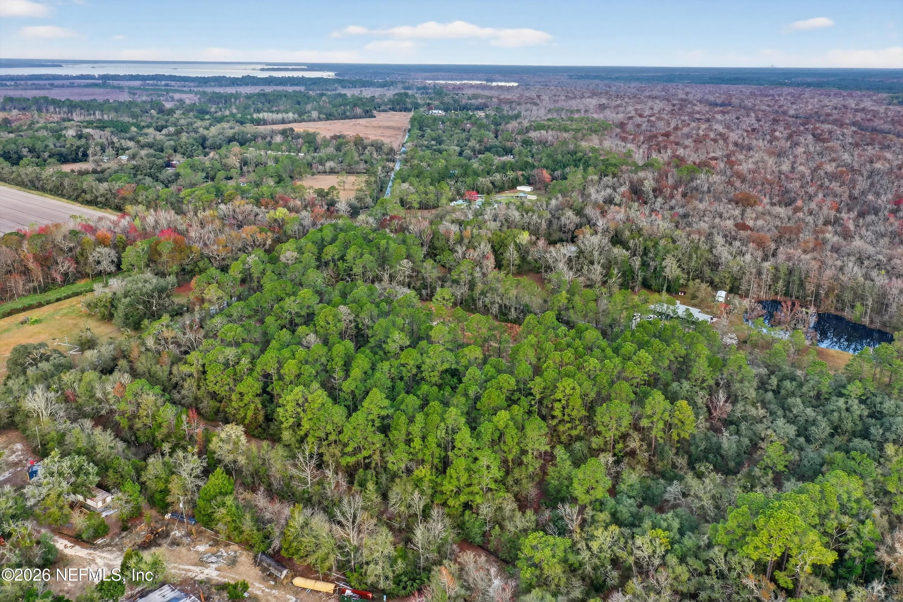 3570 Joe Ashton Road St. Augustine, FL 32092 - Photo 16 of 22 a view of a city with lush green forest