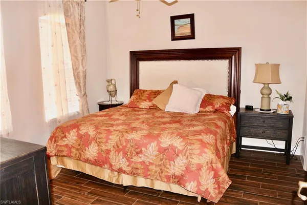 a large bed sitting in a bedroom next to a window