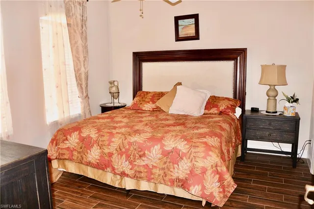 a large bed sitting in a bedroom next to a window