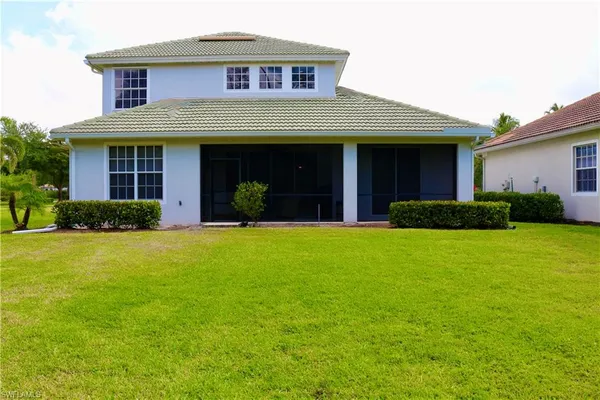 a view of a house with pool and garden