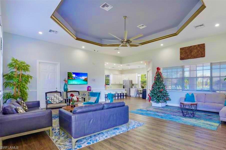 15474 Los Reyes Lane Naples, FL 34110 - Photo 29 of 36 a living room with furniture and a flat screen tv