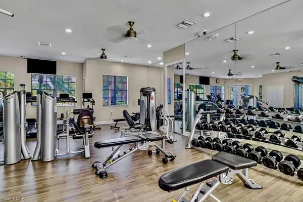 a view of a room with gym equipment and a large window