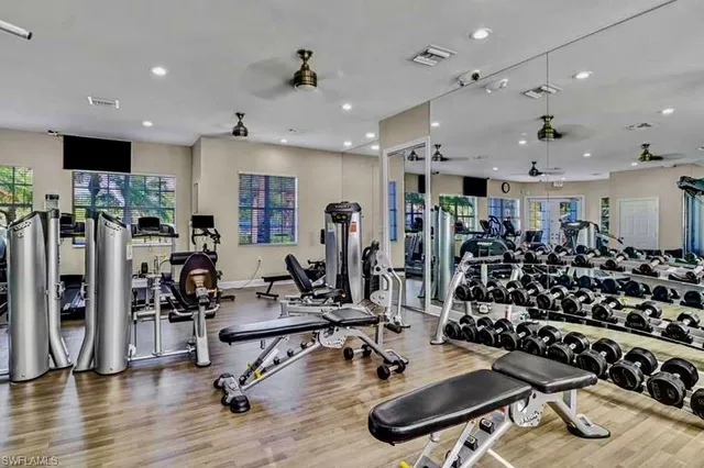 a view of a room with gym equipment and a large window