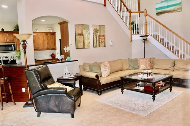 a living room with furniture and a mirror