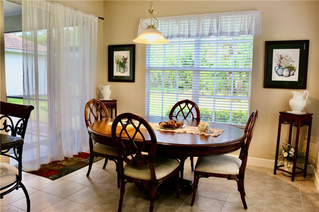 15474 Los Reyes Lane Naples, FL 34110 - Photo 10 of 36 a view of a dining room with furniture and a window
