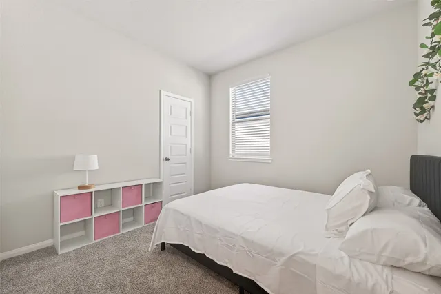 a bedroom with a bed and window