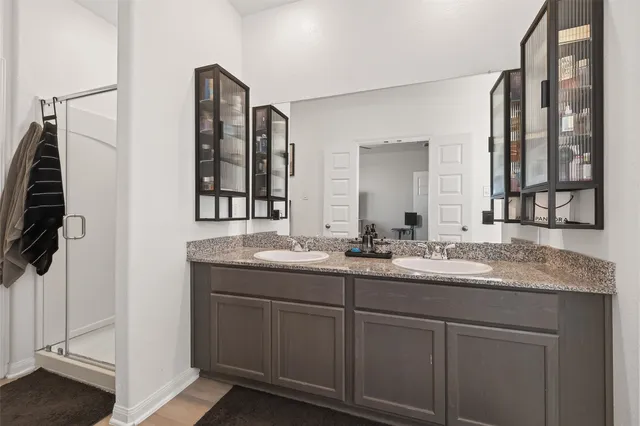 a bathroom with a double vanity sink and mirror