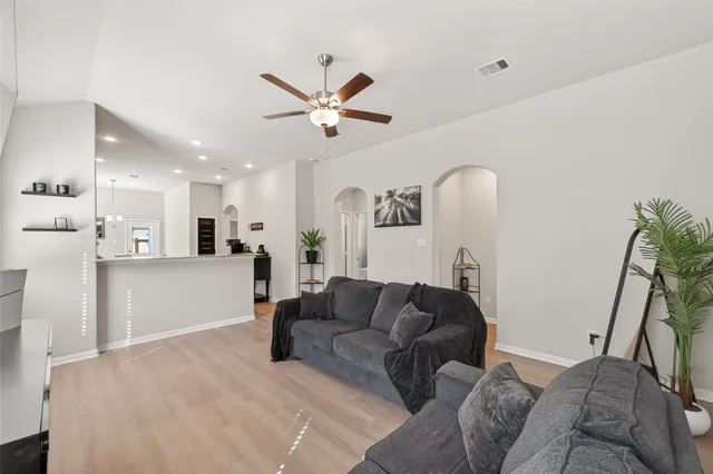 a living room with furniture and a chandelier