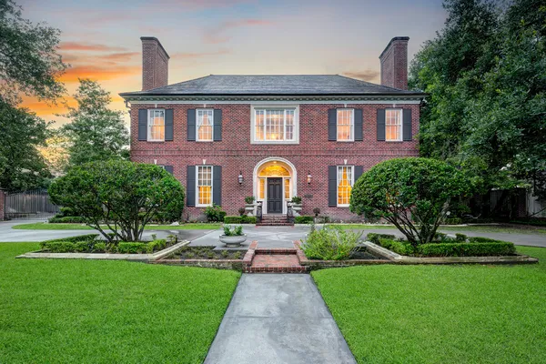 a front view of a house with garden