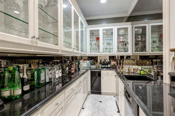 a large white bathroom with a granite countertop sink mirror and a shower