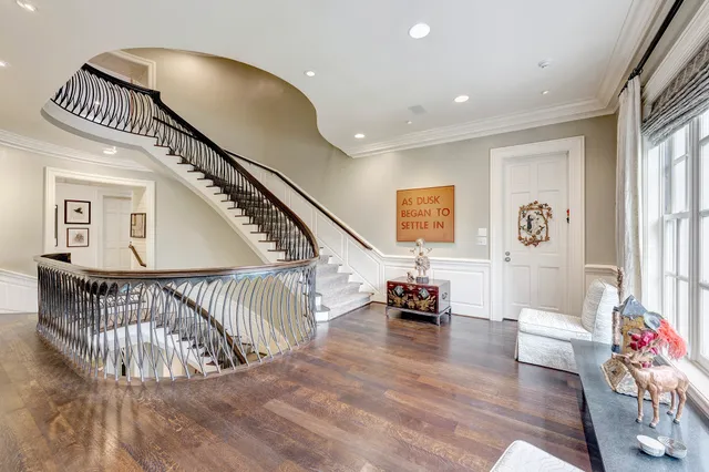 a view of staircase with furniture and a ceiling fan