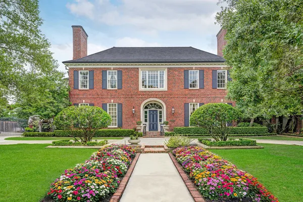 a view of a hallway with wooden floor windows and a chandelier