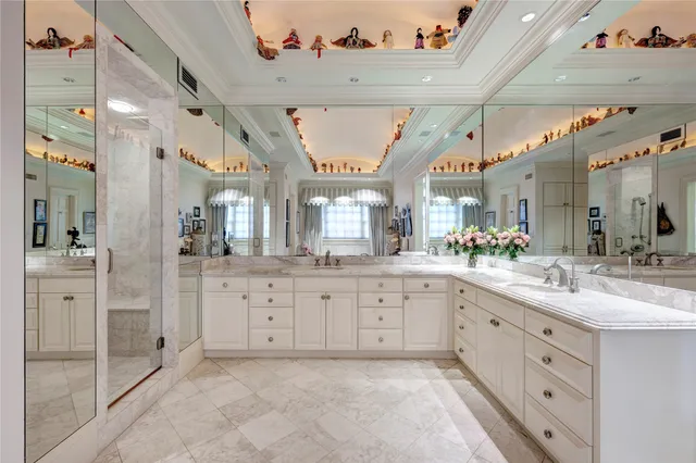a large white bathroom with a granite countertop sink mirror and a shower