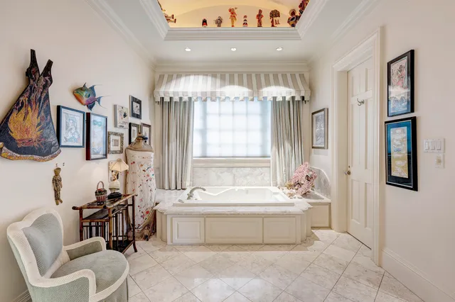 a spacious bedroom with a bed and a chandelier