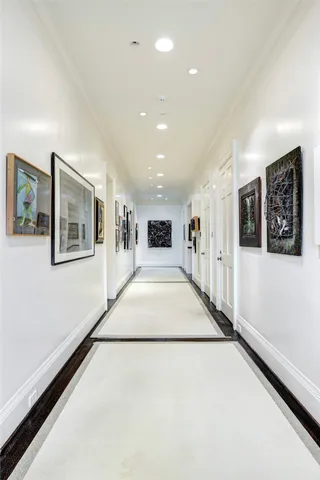 a view of a hallway with wooden floor and windows