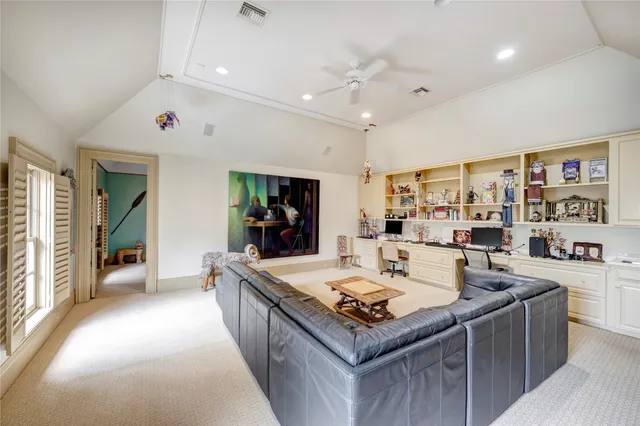 a large white kitchen with a large window and stainless steel appliances