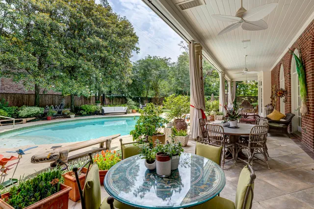 a dining room with furniture and garden view