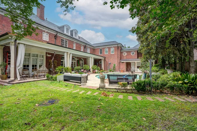 a view of a house with a yard patio and sitting area