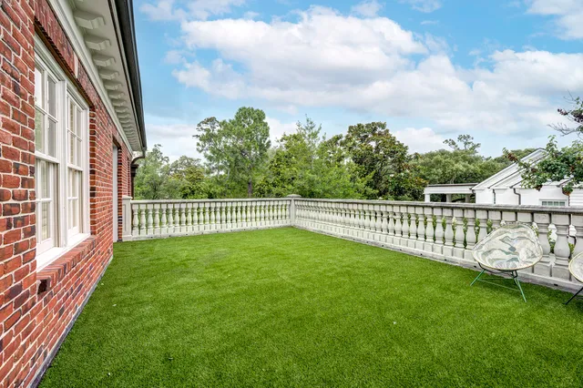 a view of a yard with wooden fence