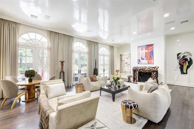 a living room with fireplace furniture and a large window