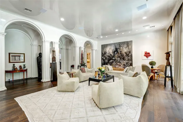 a living room with fireplace furniture and wooden floor