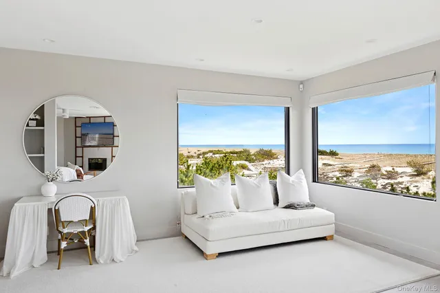 a living room with furniture and floor to ceiling window