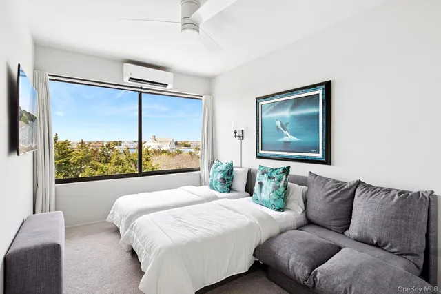 a bedroom with a large bed and a window