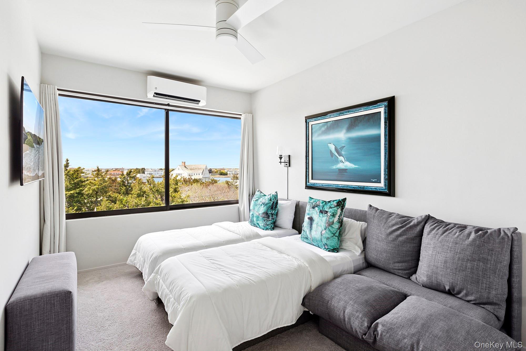 199 Dune Road Westhampton Beach, NY 11978 - Photo 21 of 38 a bedroom with a large bed and a window