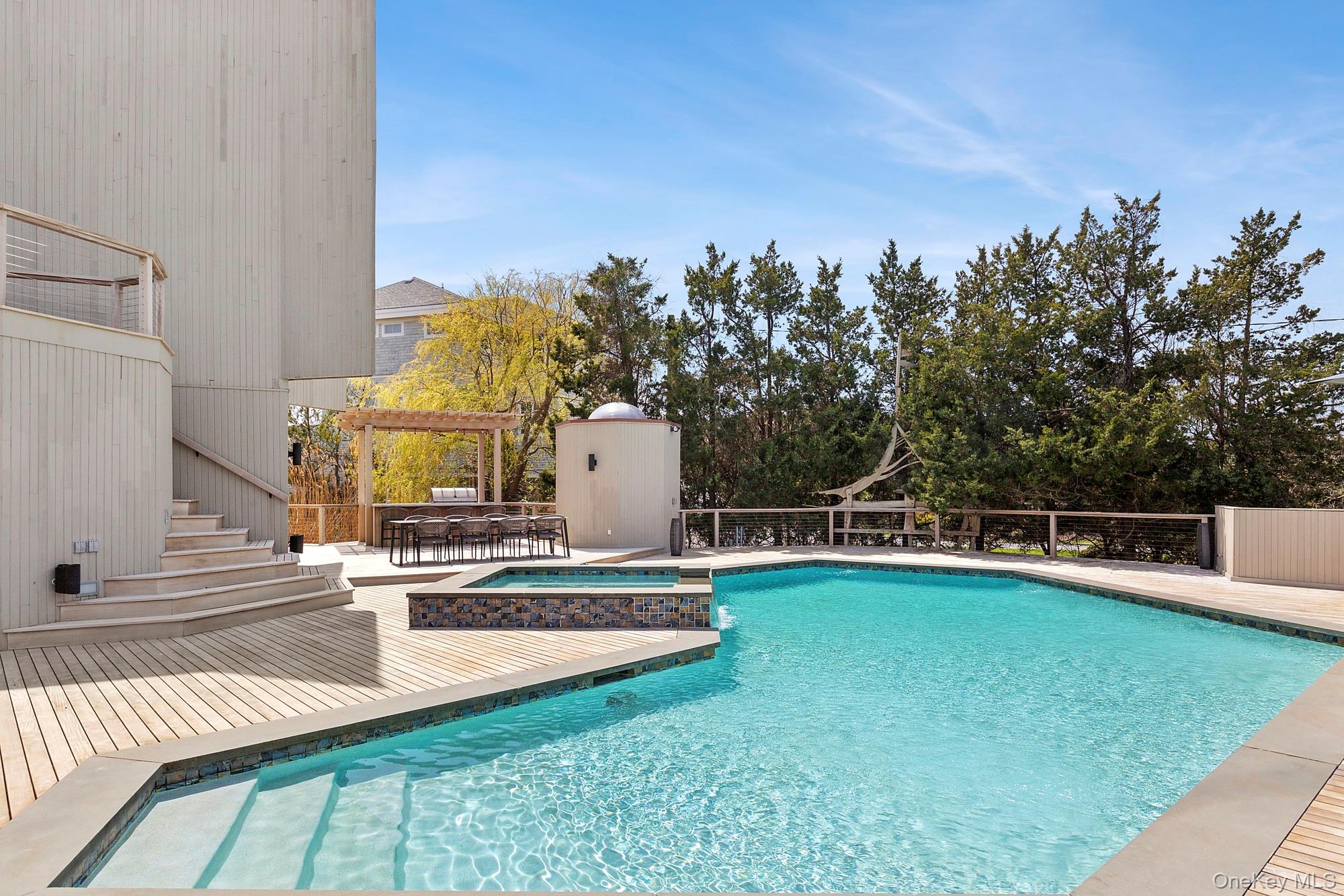 199 Dune Road Westhampton Beach, NY 11978 - Photo 23 of 38 a view of a swimming pool with a patio