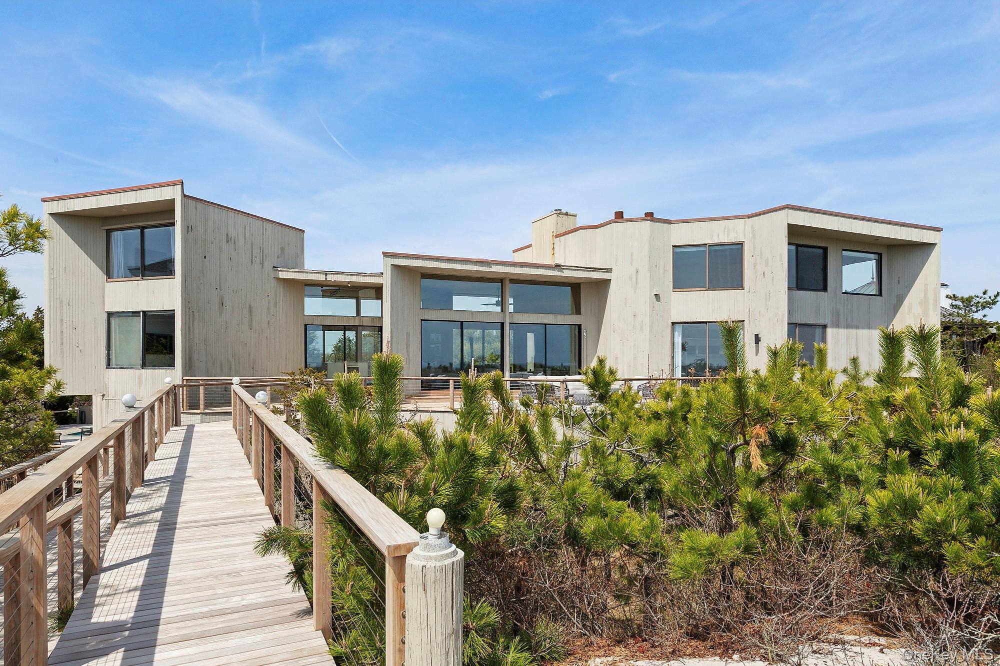 199 Dune Road Westhampton Beach, NY 11978 - Photo 29 of 38 a front view of a house with a yard