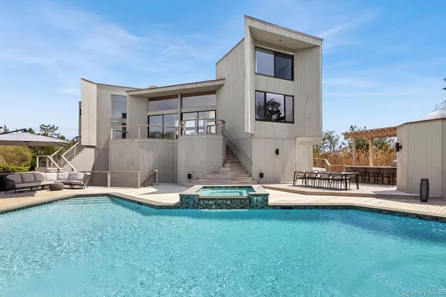 a view of a house with swimming pool and sitting area