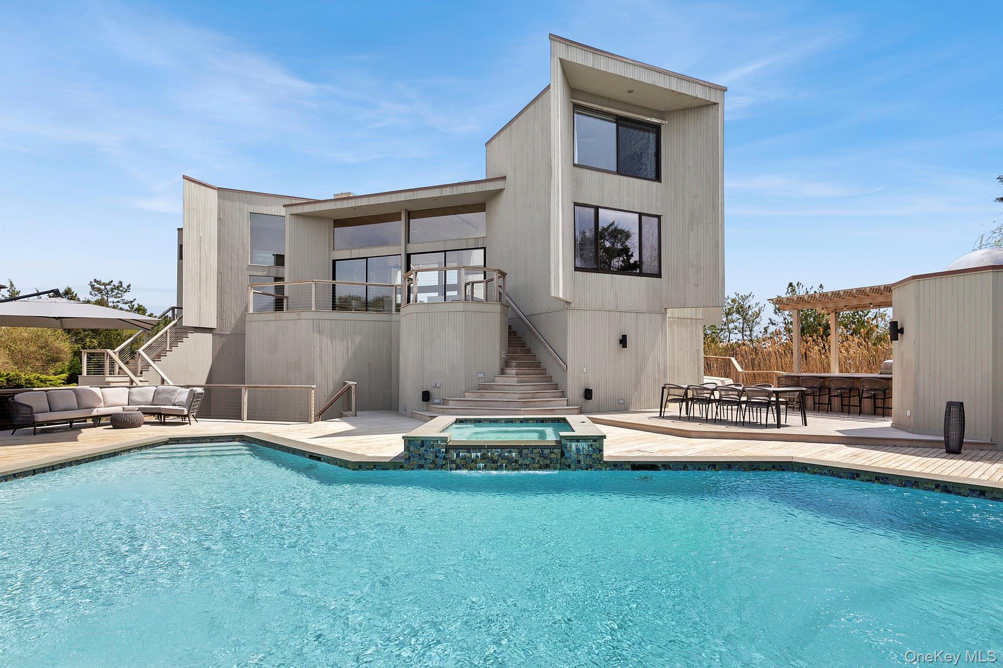199 Dune Road Westhampton Beach, NY 11978 - Photo 3 of 38 a view of a house with swimming pool and sitting area
