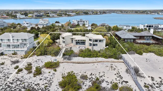 an aerial view of a house with a lake view