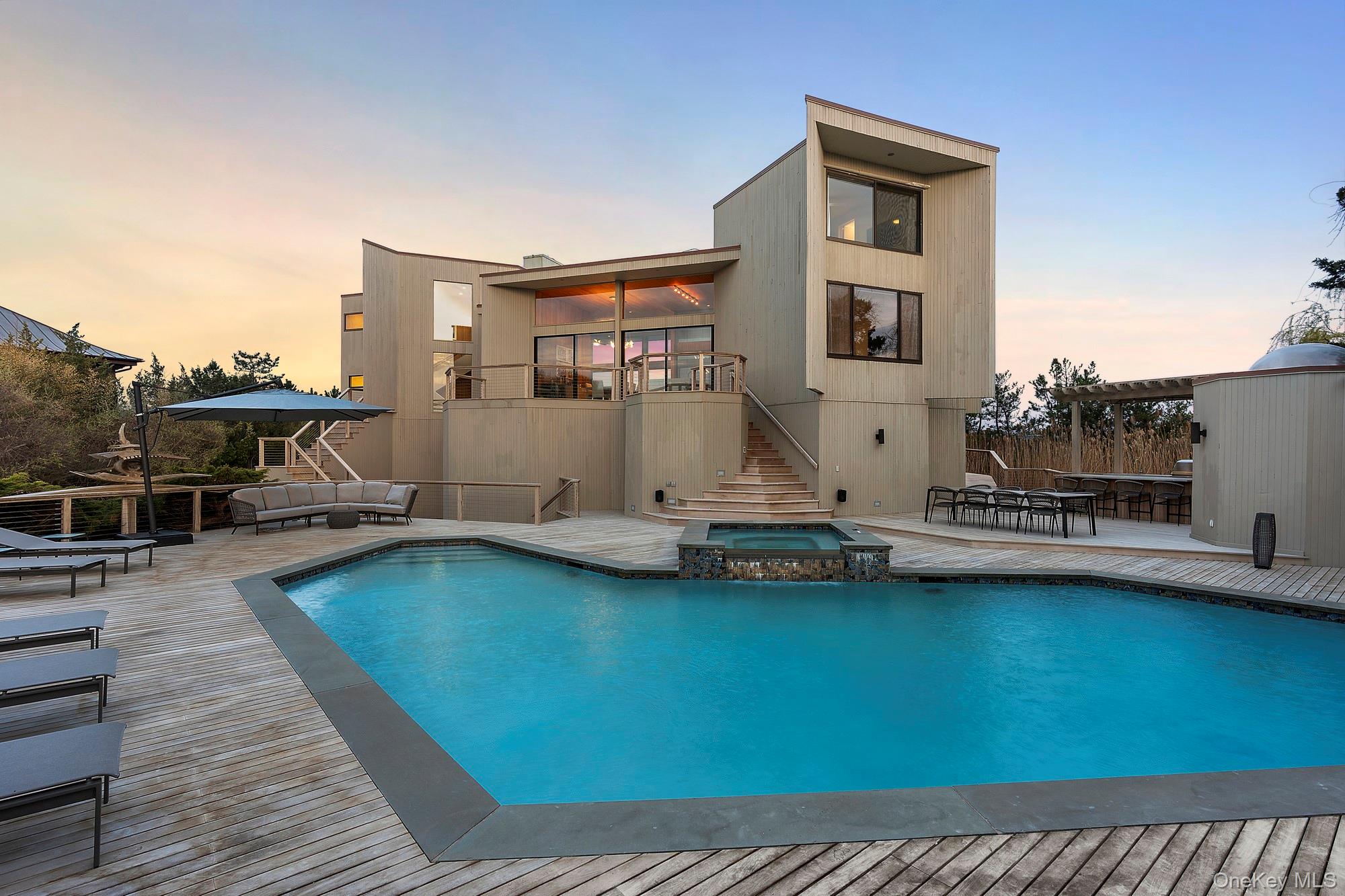 199 Dune Road Westhampton Beach, NY 11978 - Photo 36 of 38 a view of a swimming pool with lounge chair