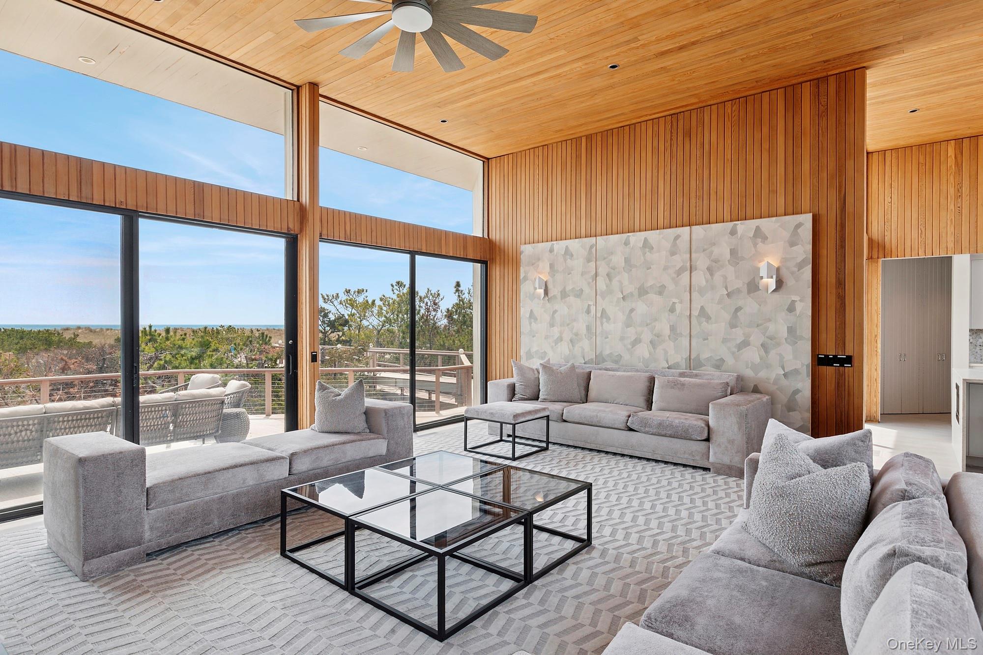 199 Dune Road Westhampton Beach, NY 11978 - Photo 6 of 38 a living room with furniture and a large window