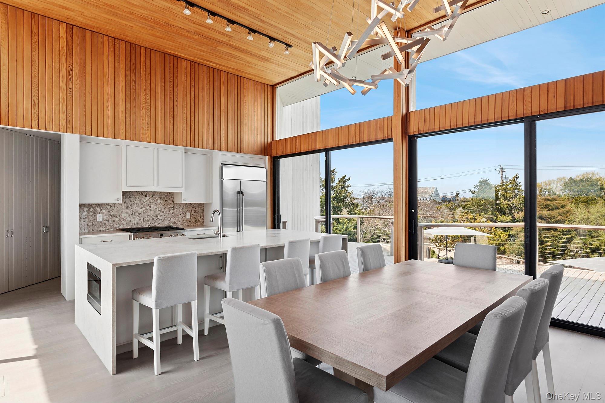 199 Dune Road Westhampton Beach, NY 11978 - Photo 9 of 38 a view of a dining room with furniture window and outside view
