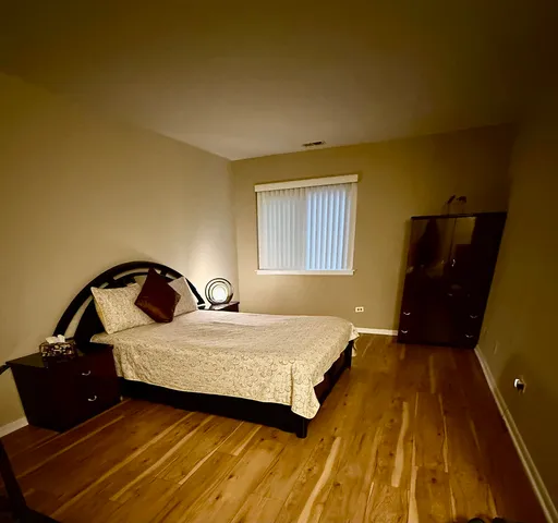 a bedroom with a bed and dresser