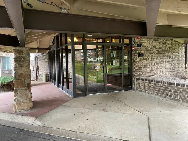 a view of a bedroom with a bed and wooden floor