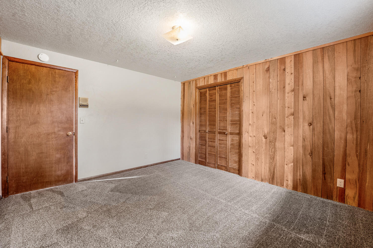 62255 Wallace Road Bend, OR 97701 - Photo 32 of 51 a view of a room with a wooden door