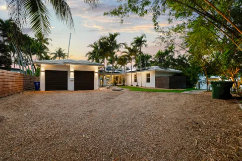 a front view of a house with a garden and yard