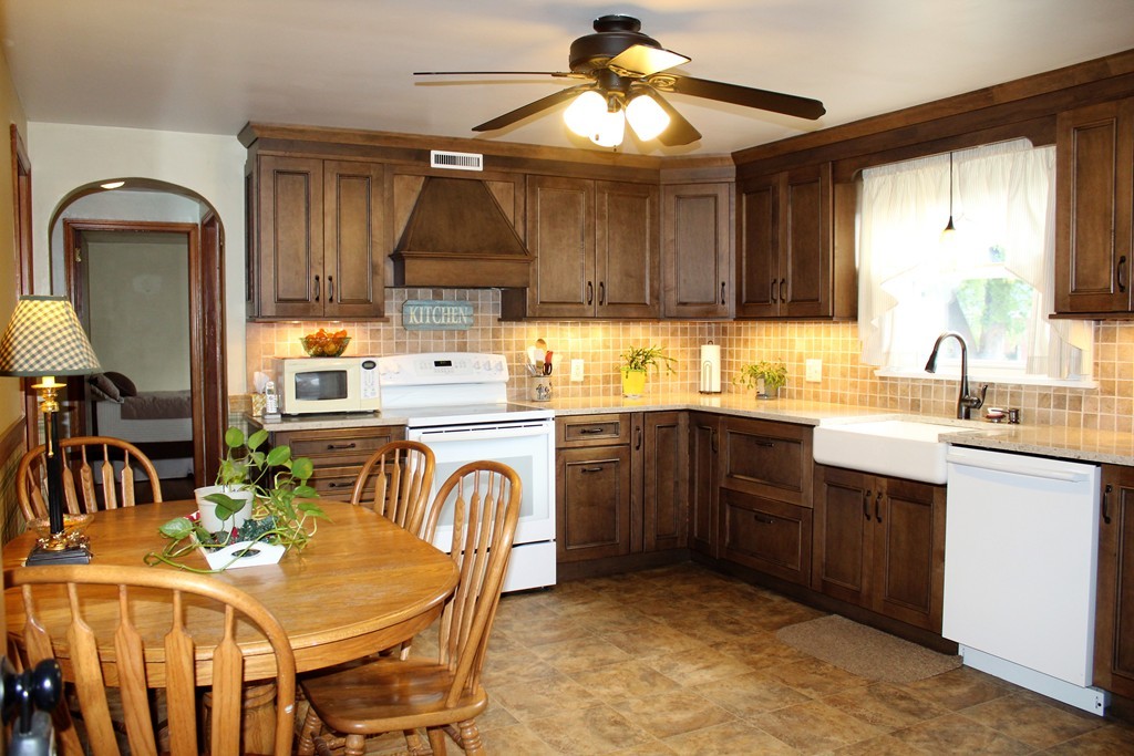 65 Primrose Street Springfield, MA 01151 - Photo 12 of 30 a kitchen with a sink cabinets a stove and a microwave