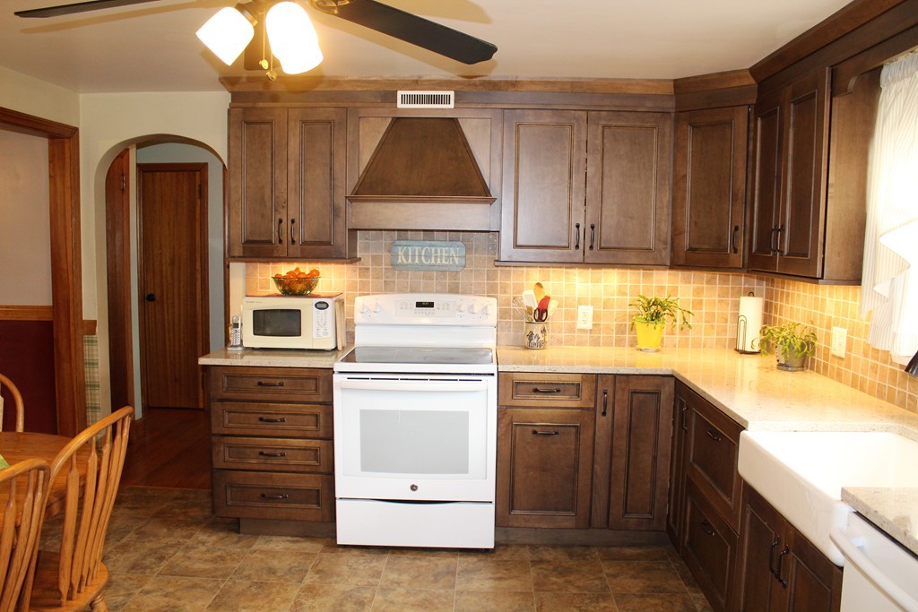 65 Primrose Street Springfield, MA 01151 - Photo 13 of 30 a kitchen with cabinets appliances and a window