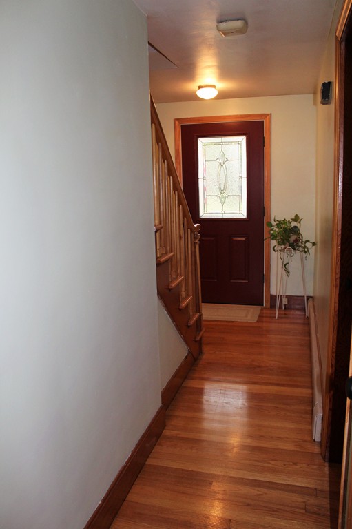 65 Primrose Street Springfield, MA 01151 - Photo 16 of 30 a view of hallway with stairs and wooden floor