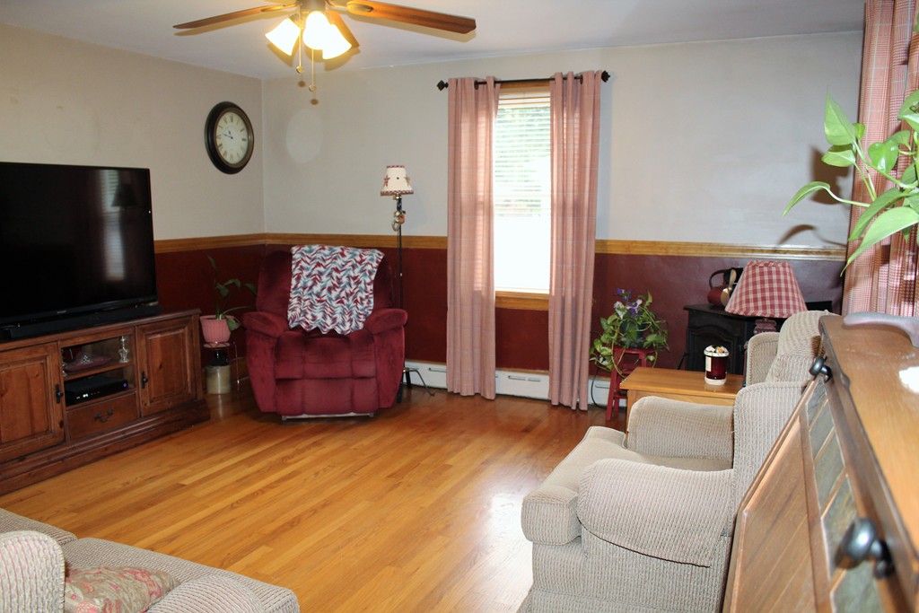 65 Primrose Street Springfield, MA 01151 - Photo 17 of 30 a living room with furniture a flat screen tv and a fireplace